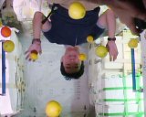 While unloading Japan's supply ship, astronaut Kimiya Yui poses upside down with fresh fruit. Image: NASA.
 